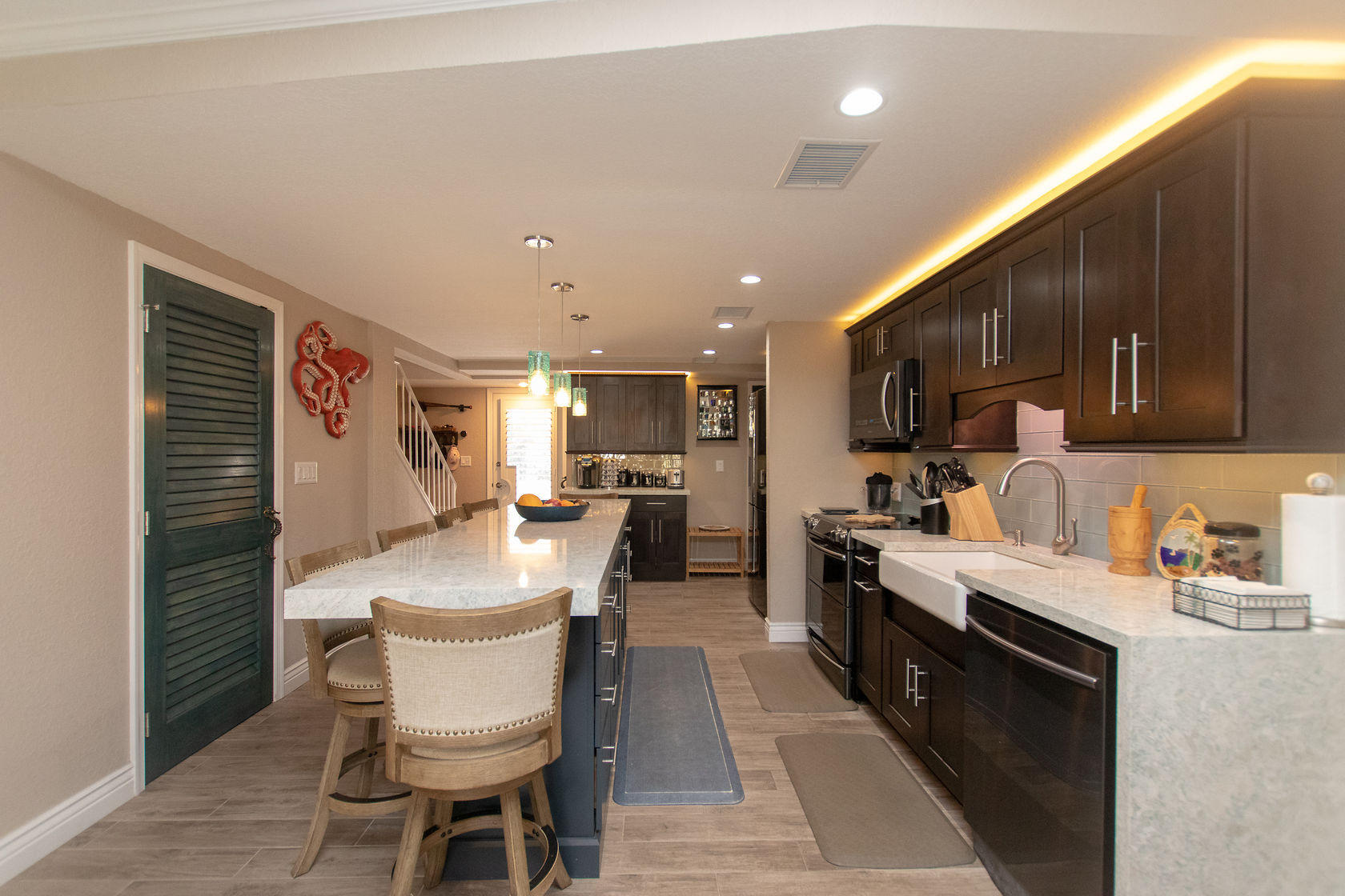 97652 Overseas Highway, Unit M11 Key Largo, FL 33037 - Photo 16 of 48 a large kitchen with a table and chairs