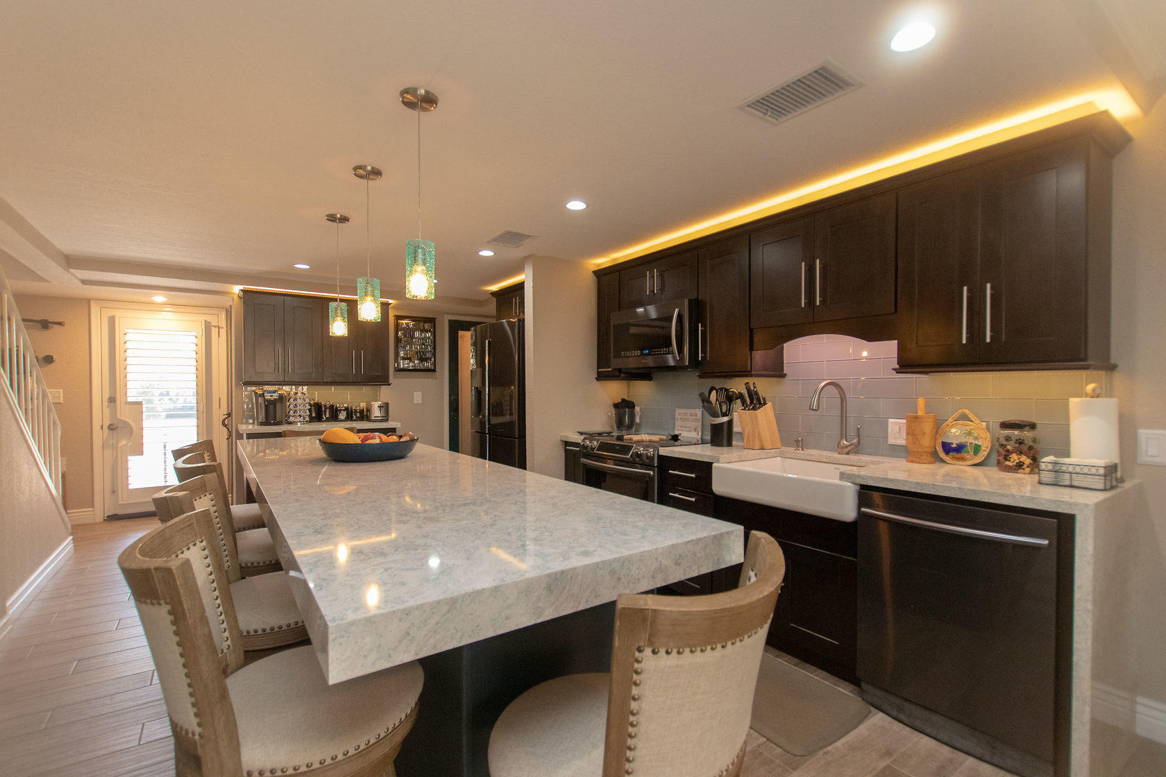 97652 Overseas Highway, Unit M11 Key Largo, FL 33037 - Photo 17 of 48 a kitchen with a table chairs stove top oven and cabinets