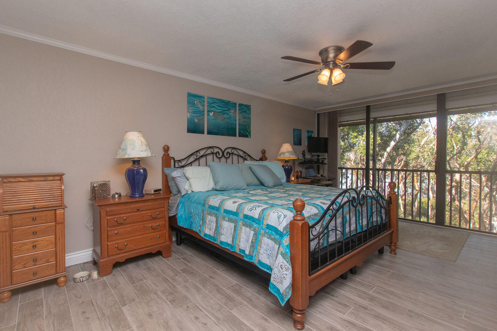 97652 Overseas Highway, Unit M11 Key Largo, FL 33037 - Photo 24 of 48 a bedroom with a bed and a chandelier