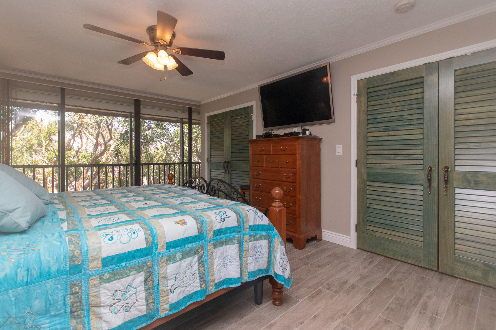 97652 Overseas Highway, Unit M11 Key Largo, FL 33037 - Photo 25 of 48 a bedroom with a bed and a flat screen tv