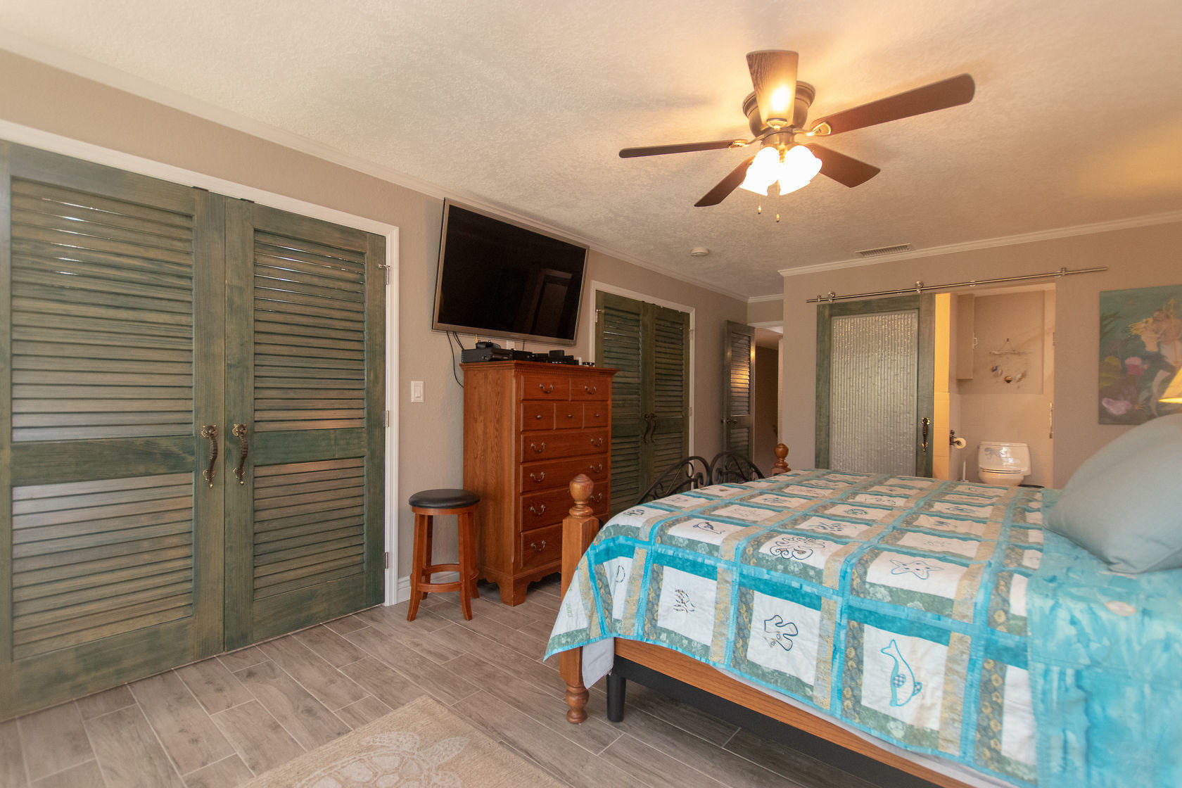 97652 Overseas Highway, Unit M11 Key Largo, FL 33037 - Photo 27 of 48 a bedroom with a bed and a flat tv screen on dresser