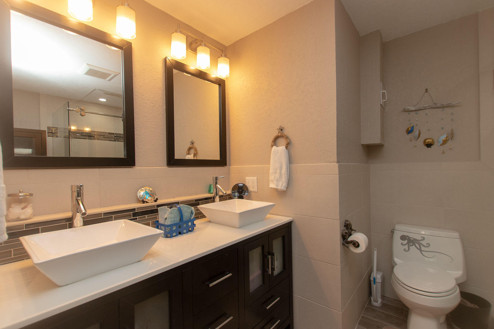 97652 Overseas Highway, Unit M11 Key Largo, FL 33037 - Photo 29 of 48 a bathroom with a double vanity sink toilet and a mirror