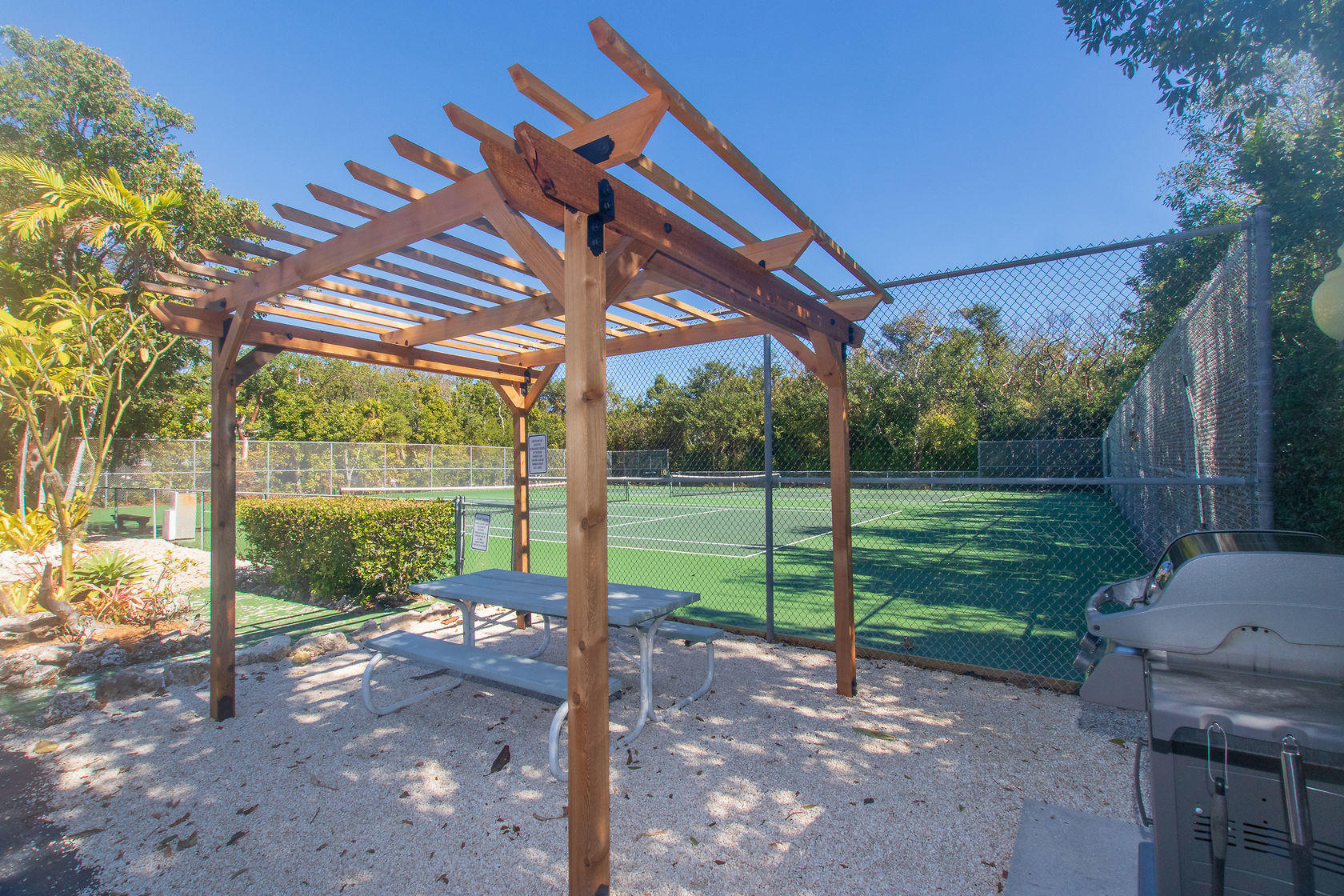 97652 Overseas Highway, Unit M11 Key Largo, FL 33037 - Photo 35 of 48 a view of a backyard with plants and a backyard