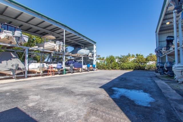 97652 Overseas Highway, Unit M11 Key Largo, FL 33037 - Photo 46 of 48 a view of a patio with a table and chairs under an umbrella
