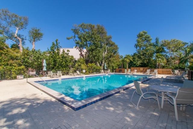 97652 Overseas Highway, Unit M11 Key Largo, FL 33037 - Photo 47 of 48 a view of a swimming pool with a patio and a yard