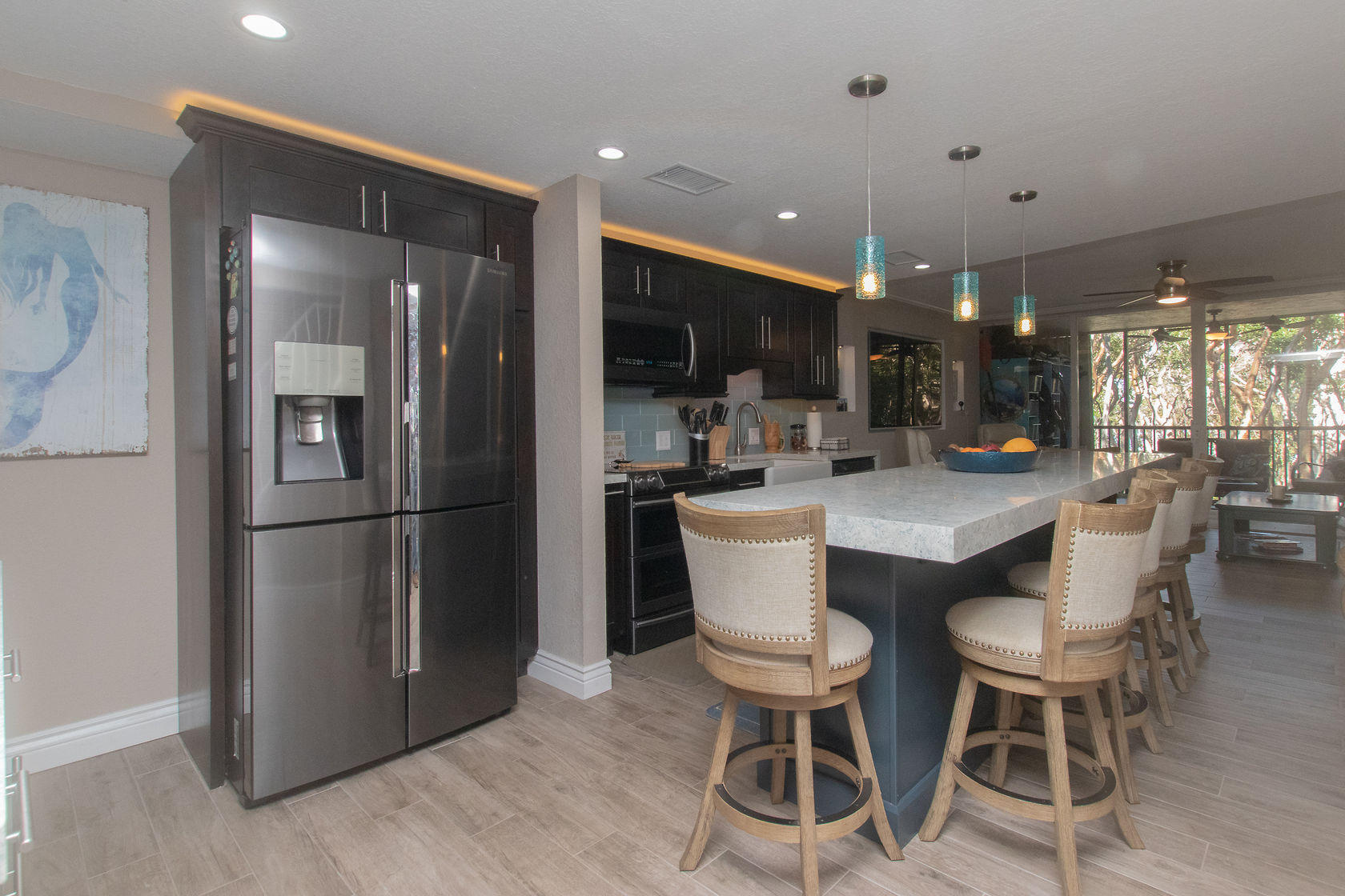 97652 Overseas Highway, Unit M11 Key Largo, FL 33037 - Photo 5 of 48 a kitchen with a dining table chairs refrigerator and microwave