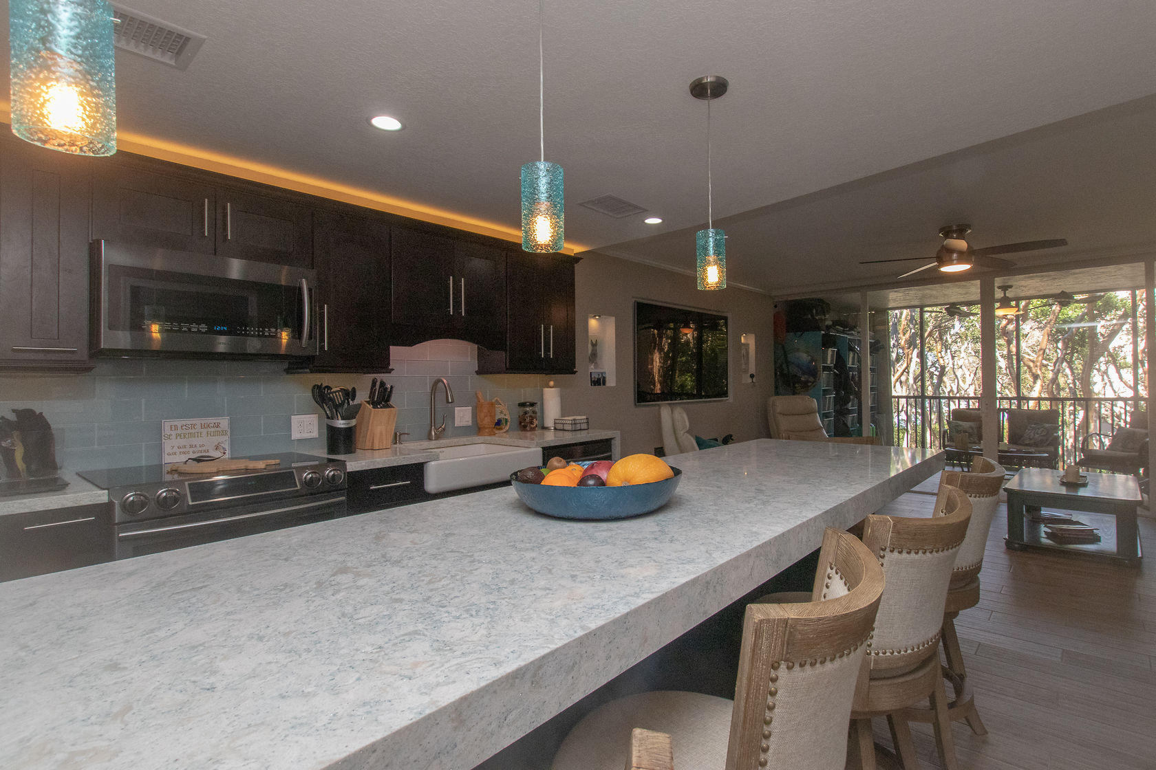 97652 Overseas Highway, Unit M11 Key Largo, FL 33037 - Photo 8 of 48 a kitchen with stainless steel appliances a sink a stove a refrigerator a microwave oven with chairs and cabinets