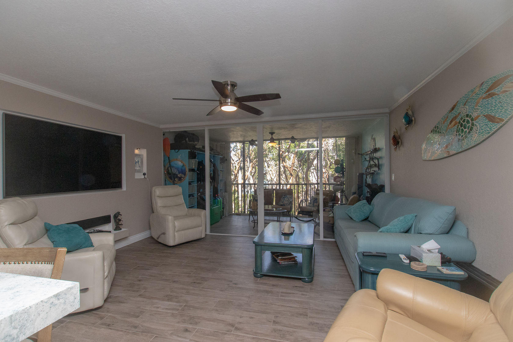 97652 Overseas Highway, Unit M11 Key Largo, FL 33037 - Photo 9 of 48 a living room with furniture and a flat screen tv