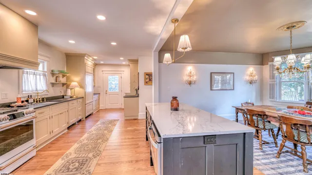 a hallway with cabinets a wooden floor and a large window