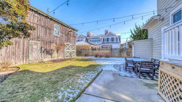 a view of a patio with table and chairs and potted plants