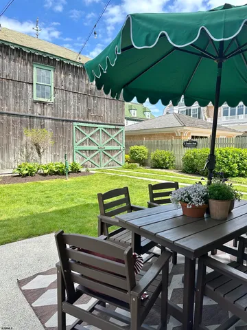 a view of a chairs and table in backyard