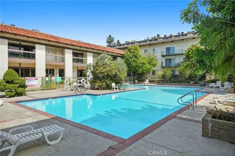 a view of a house with swimming pool and a porch