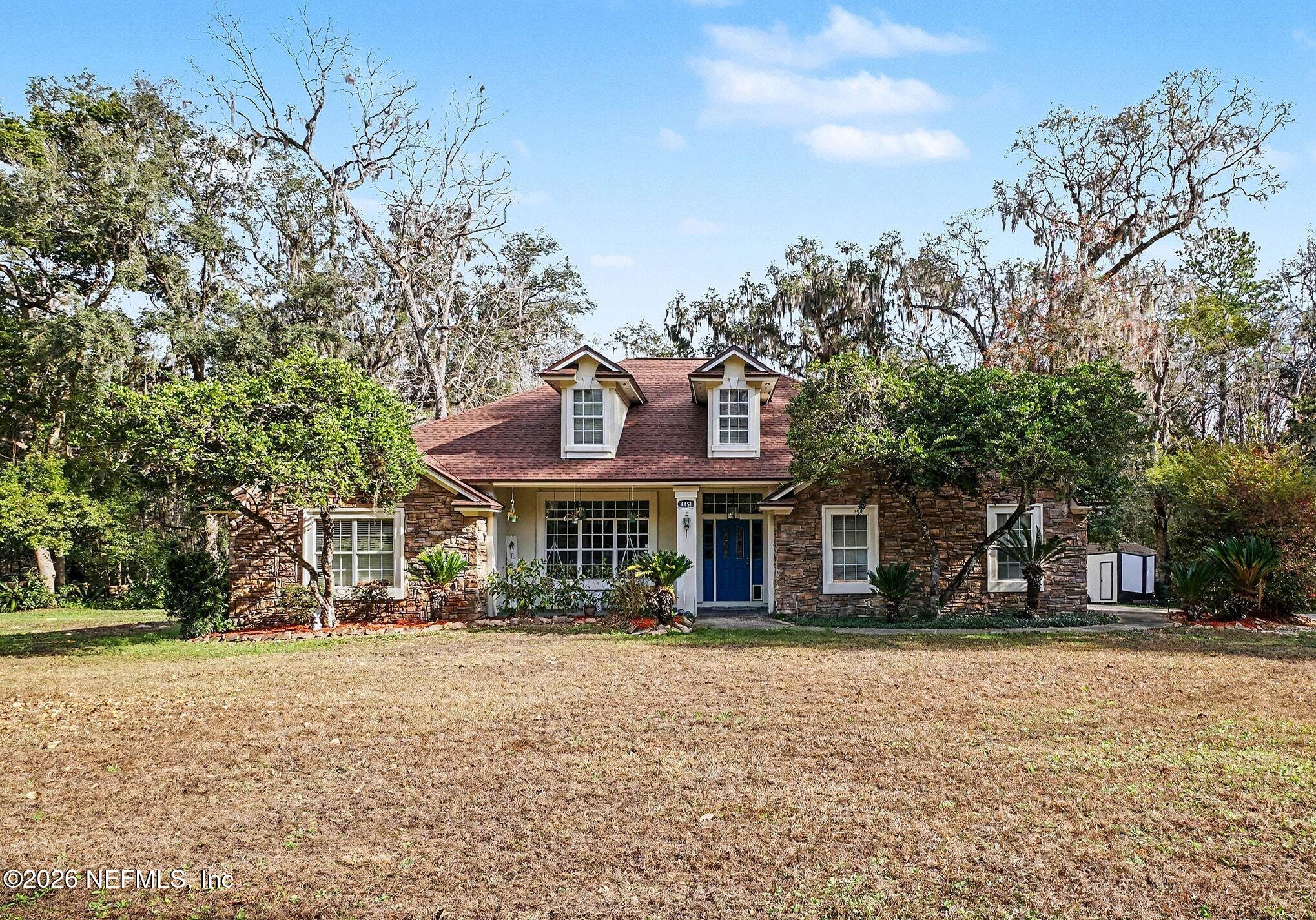 a front view of a building with a garden