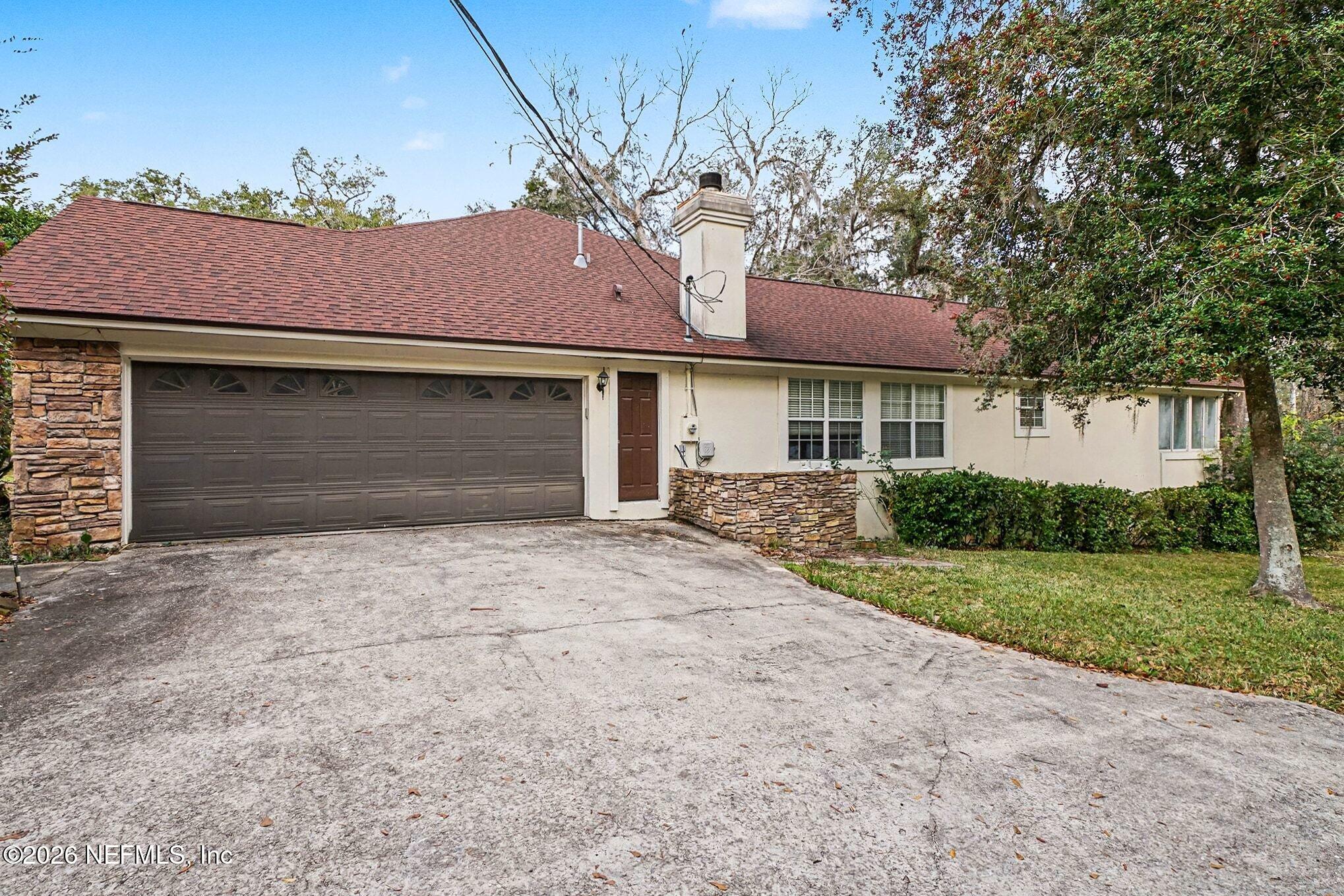 4451 Barber Road Macclenny, FL 32063 - Photo 14 of 18 a front view of a house with a yard and garage
