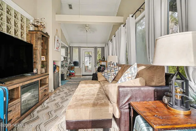 a living room with furniture and a flat screen tv