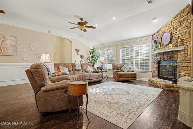 a living room with furniture ceiling fan and a fireplace