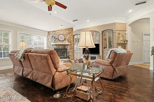 a living room with furniture a fireplace and a flat screen tv