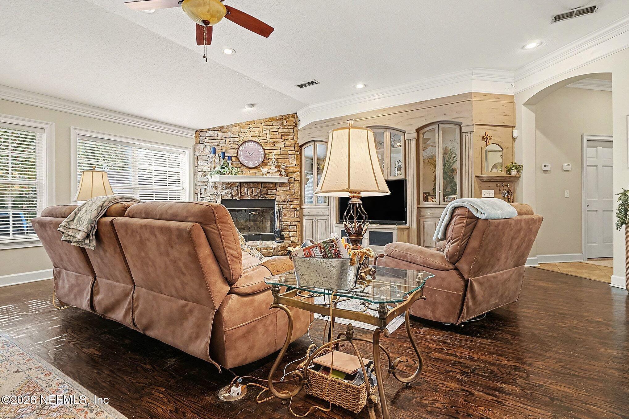 4451 Barber Road Macclenny, FL 32063 - Photo 4 of 18 a living room with furniture a fireplace and a flat screen tv