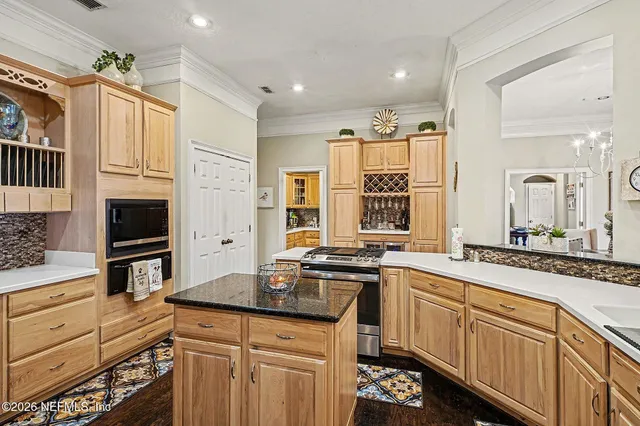 a kitchen with granite countertop a sink stainless steel appliances and cabinets