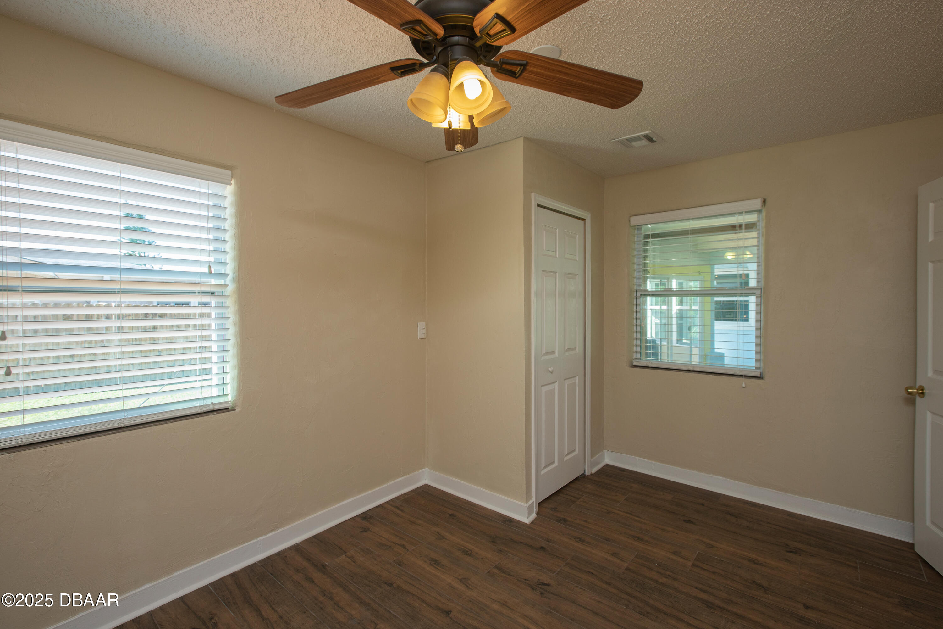 131 Minerva Road Daytona Beach, FL 32118 - Photo 14 of 21 a view of an empty room with window and wooden floor
