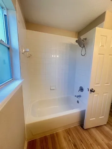 a bathroom with a bathtub and a shower