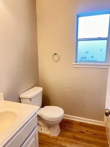a white toilet sitting next to a window