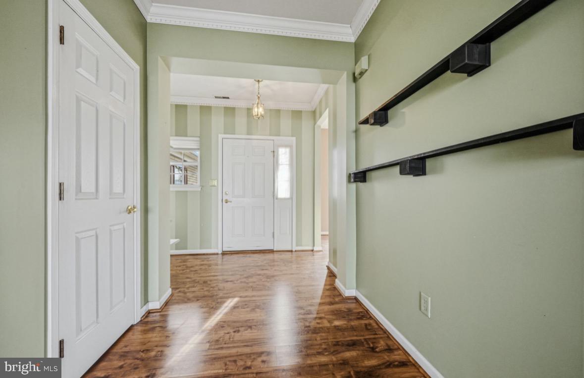 304 Daylilly Way Middletown, DE 19709 - Photo 3 of 20 a view of a hallway with wooden floor and staircase