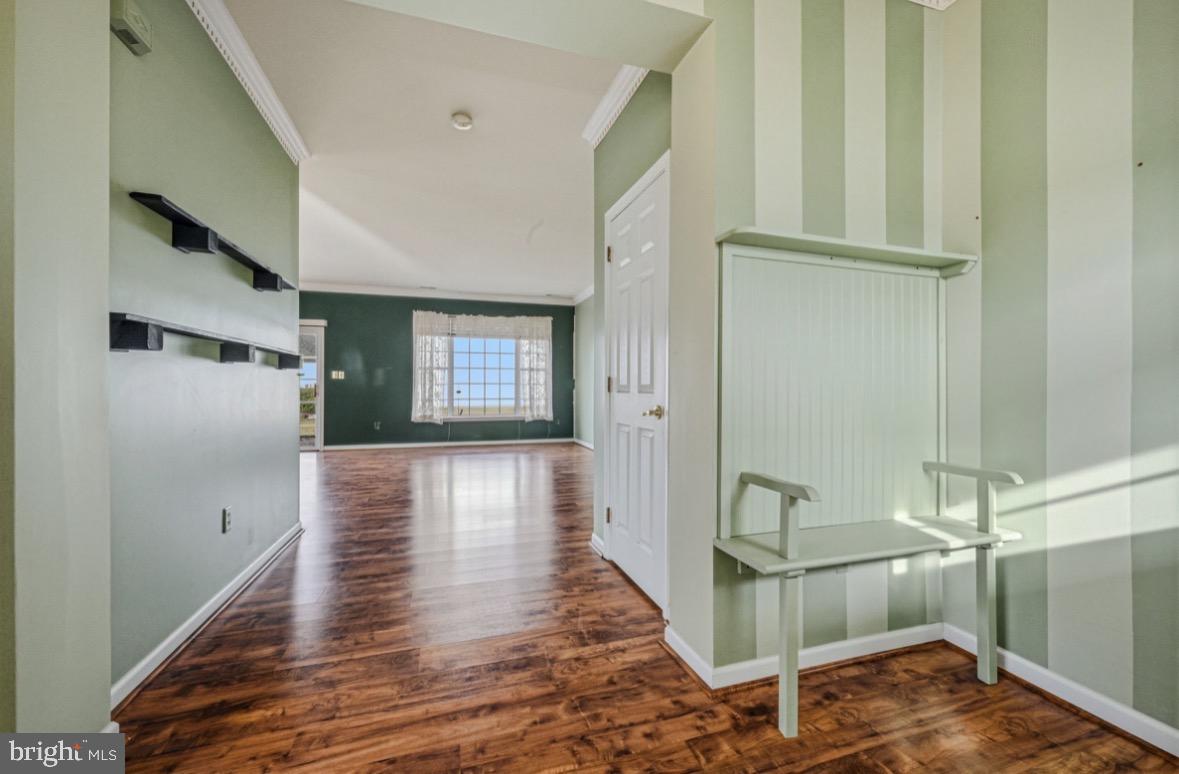 304 Daylilly Way Middletown, DE 19709 - Photo 4 of 20 a view of a hallway with wooden floor and staircase