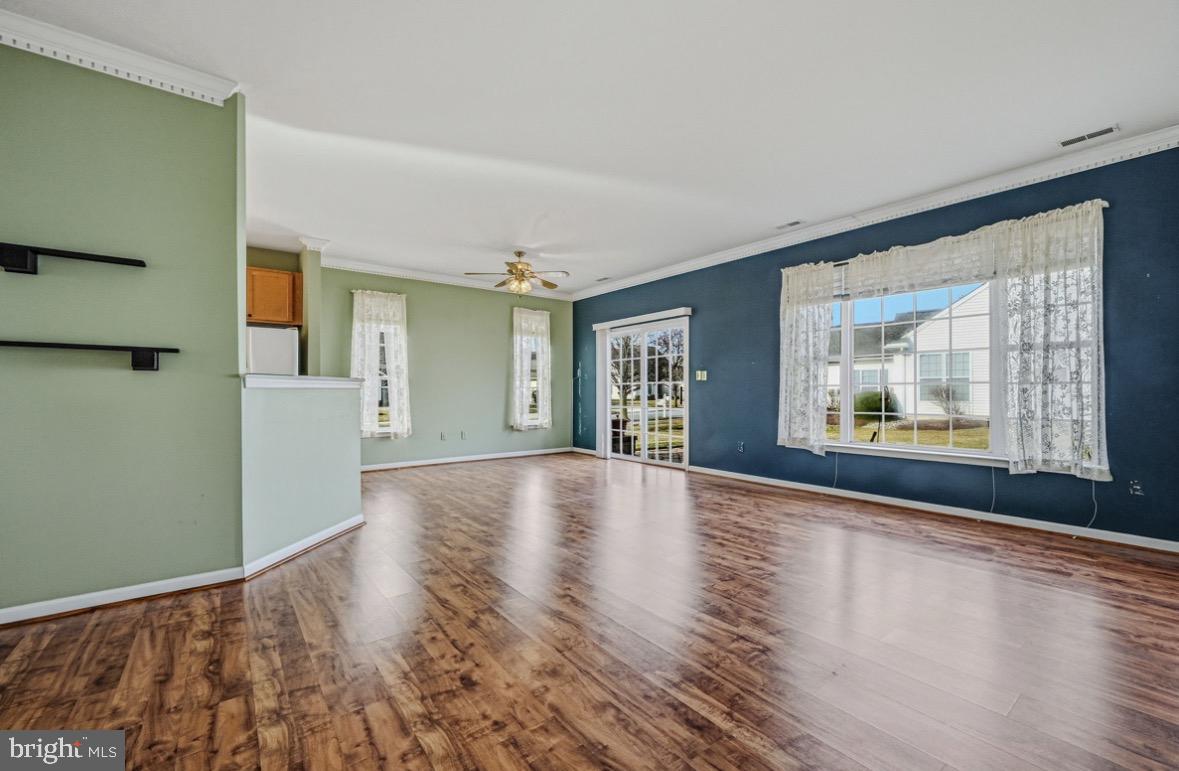304 Daylilly Way Middletown, DE 19709 - Photo 5 of 20 a view of an empty room with a window and wooden floor