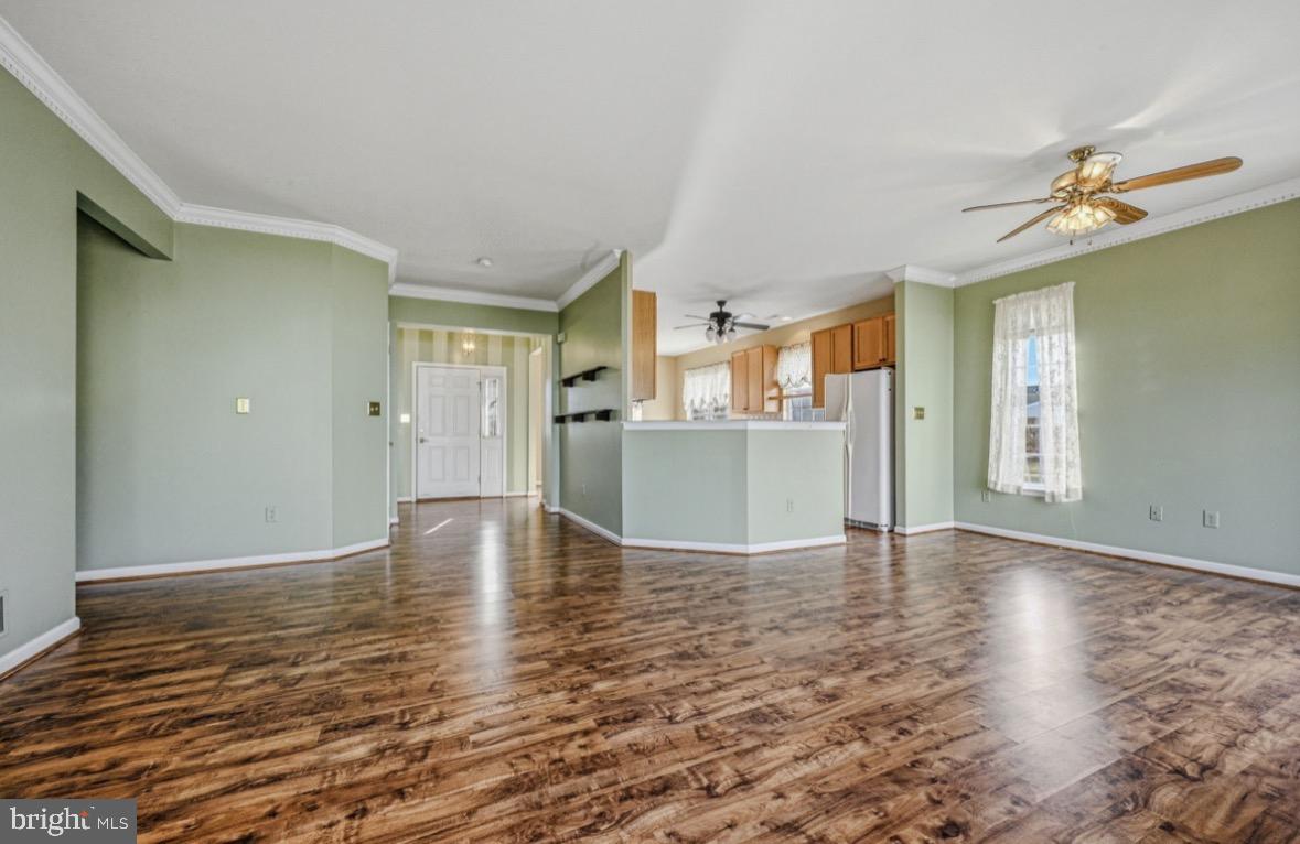 304 Daylilly Way Middletown, DE 19709 - Photo 7 of 20 a view of an empty room with window and wooden floor