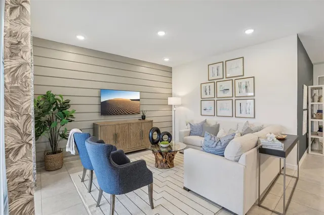 a living room with furniture and a potted plant