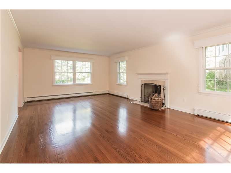 39 Barringer Road Darien, CT 06820 - Photo 5 of 25 a view of empty room with fireplace and wooden floor