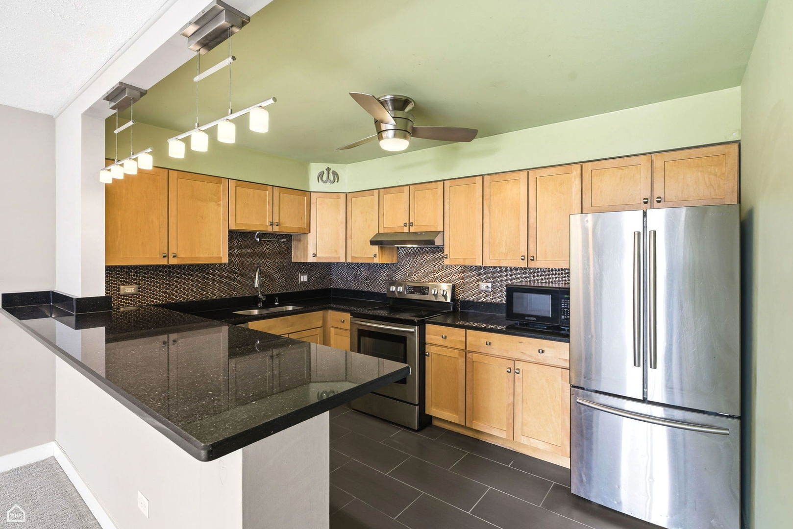 250 Ridge Avenue, Unit 4H Evanston, IL 60202 - Photo 6 of 17 a kitchen with granite countertop a sink stainless steel appliances and window
