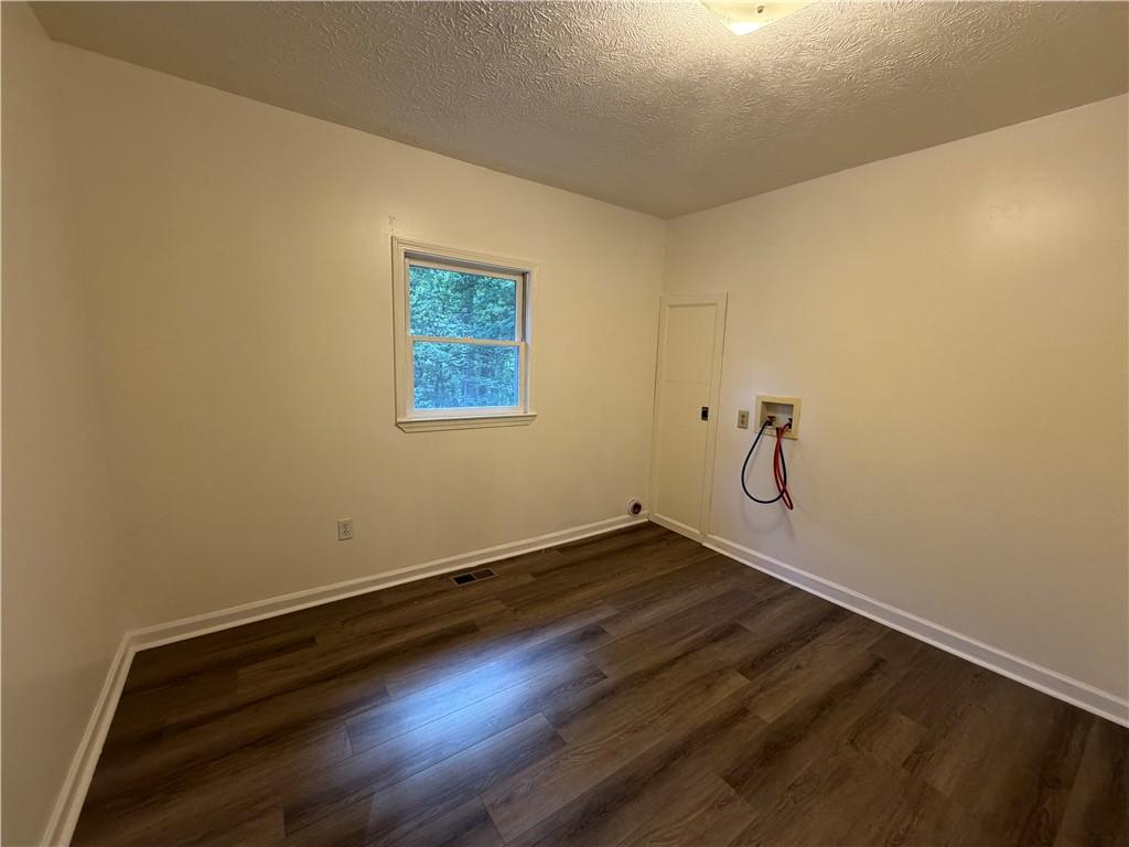 86 Robert Jones Road Dawsonville, GA 30534 - Photo 13 of 19 an empty room with a wooden floor and windows