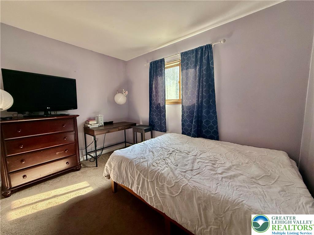 193 Canterbury Road Bushkill, PA 18324 - Photo 13 of 32 a bedroom with a bed and a flat screen tv