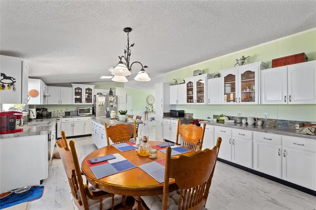 a dining room filled with furniture and wooden floor