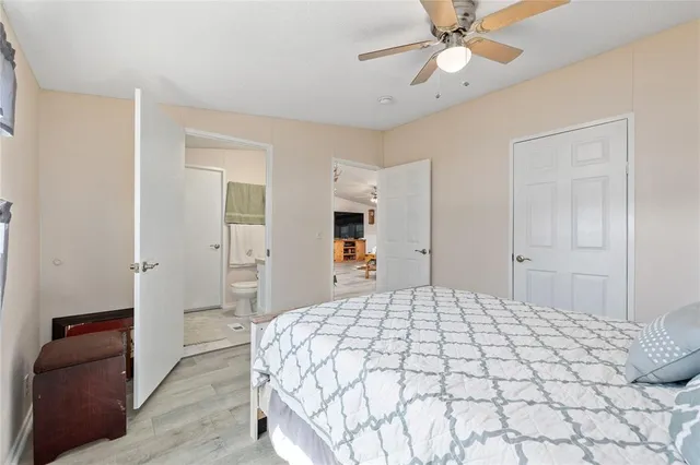 a bedroom with a large bed and a chandelier