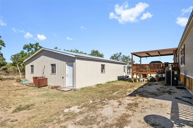 a view of a chair and table on the wooden deck