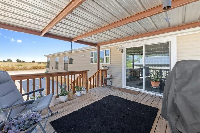 a view of a two chairs in the balcony