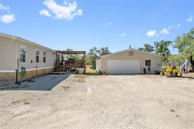a view of a house with a yard and garage