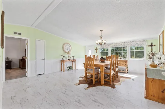 a view of a livingroom with furniture table and chairs