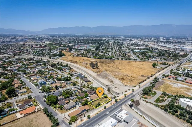 an aerial view of residential building and ocean view in back