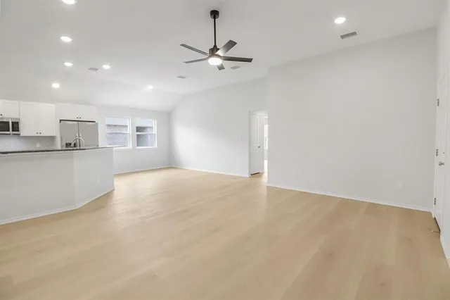 a view of a kitchen with a sink and a window