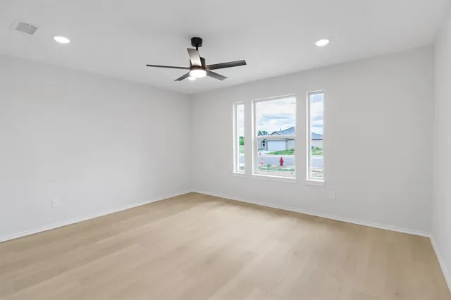 an empty room with closet and windows
