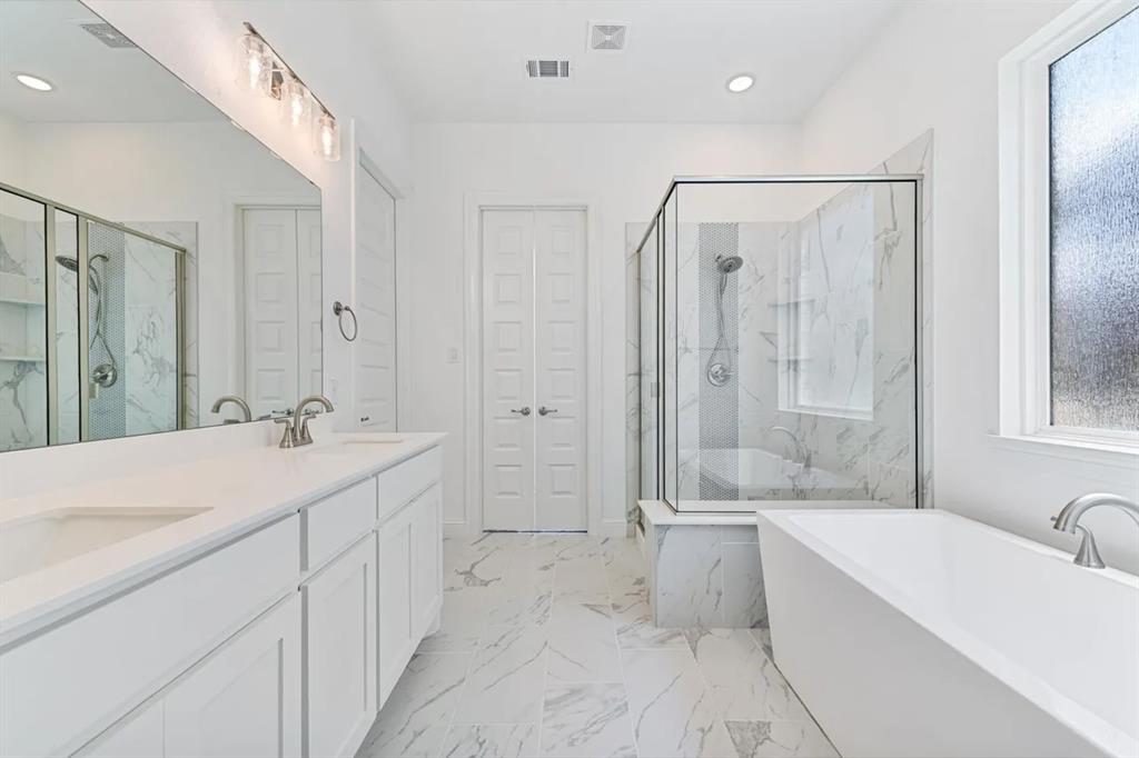 9337 Loggerhead Way Fort Worth, TX 76118 - Photo 26 of 40 a spacious bathroom with a tub sink shower and mirror