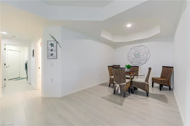 a view of a hallway with furniture and wooden floor
