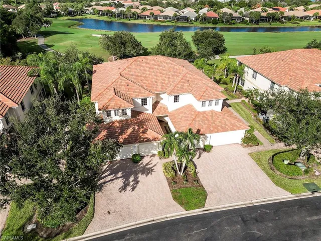 an aerial view of a house with garden space and lake view