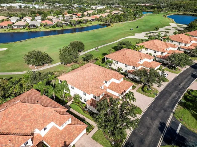 an aerial view of a residential houses with outdoor space and street view