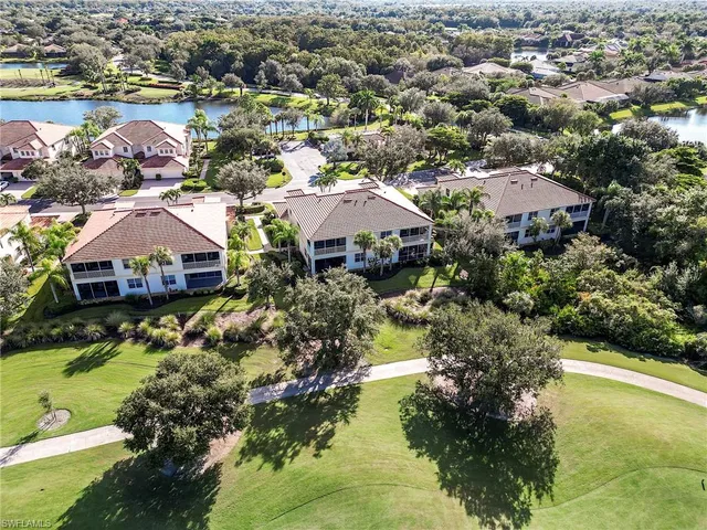 an aerial view of a house with a garden and lake view