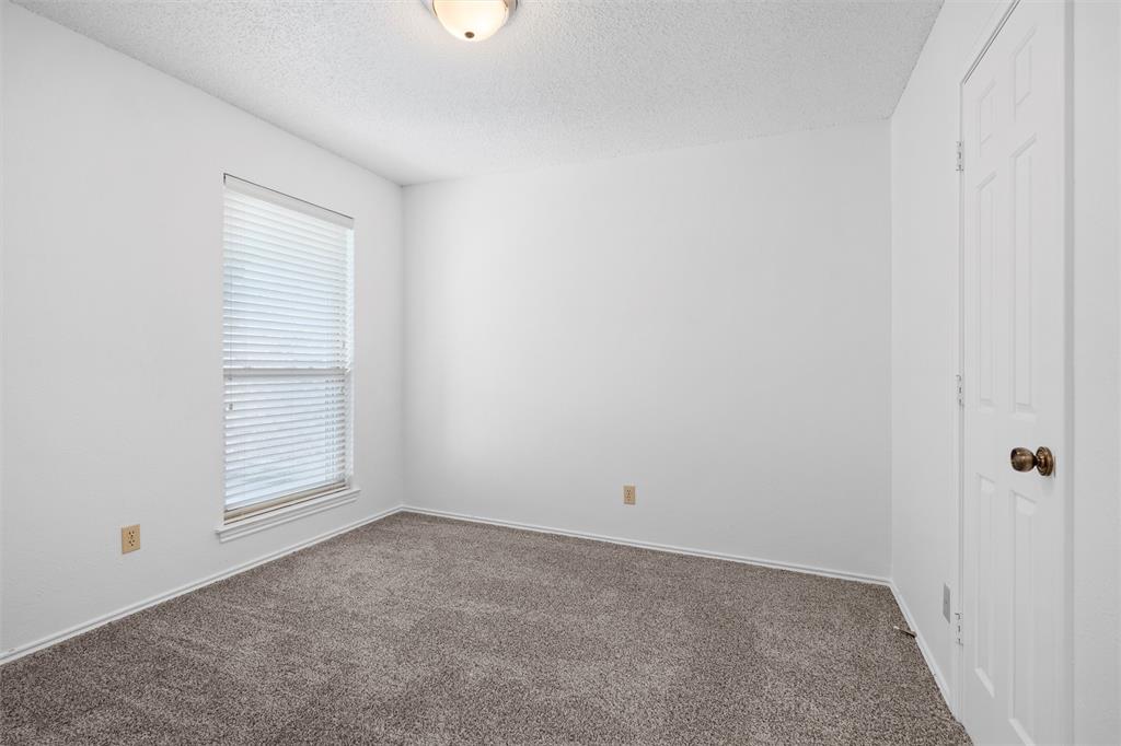 921 Red Oak Street Azle, TX 76020 - Photo 14 of 16 Bedroom #3 with carpet floors and a textured ceiling